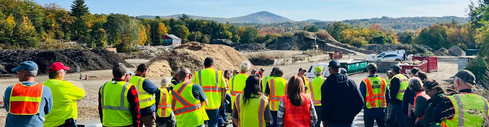 Group of solid waste operators looking at a mountain