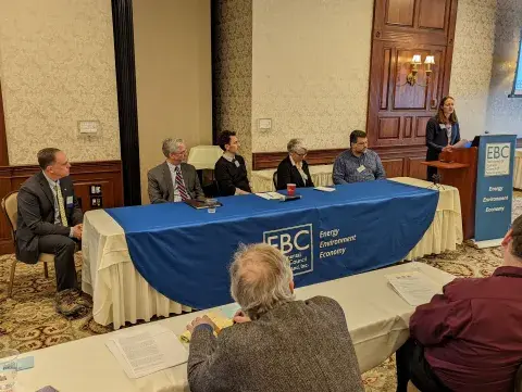 Speakers at table and podium