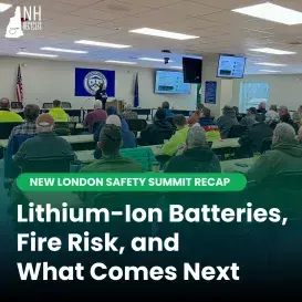 Full classroom of men listening to woman speaking at front of room with image of lithium battery on nearby presentation screen