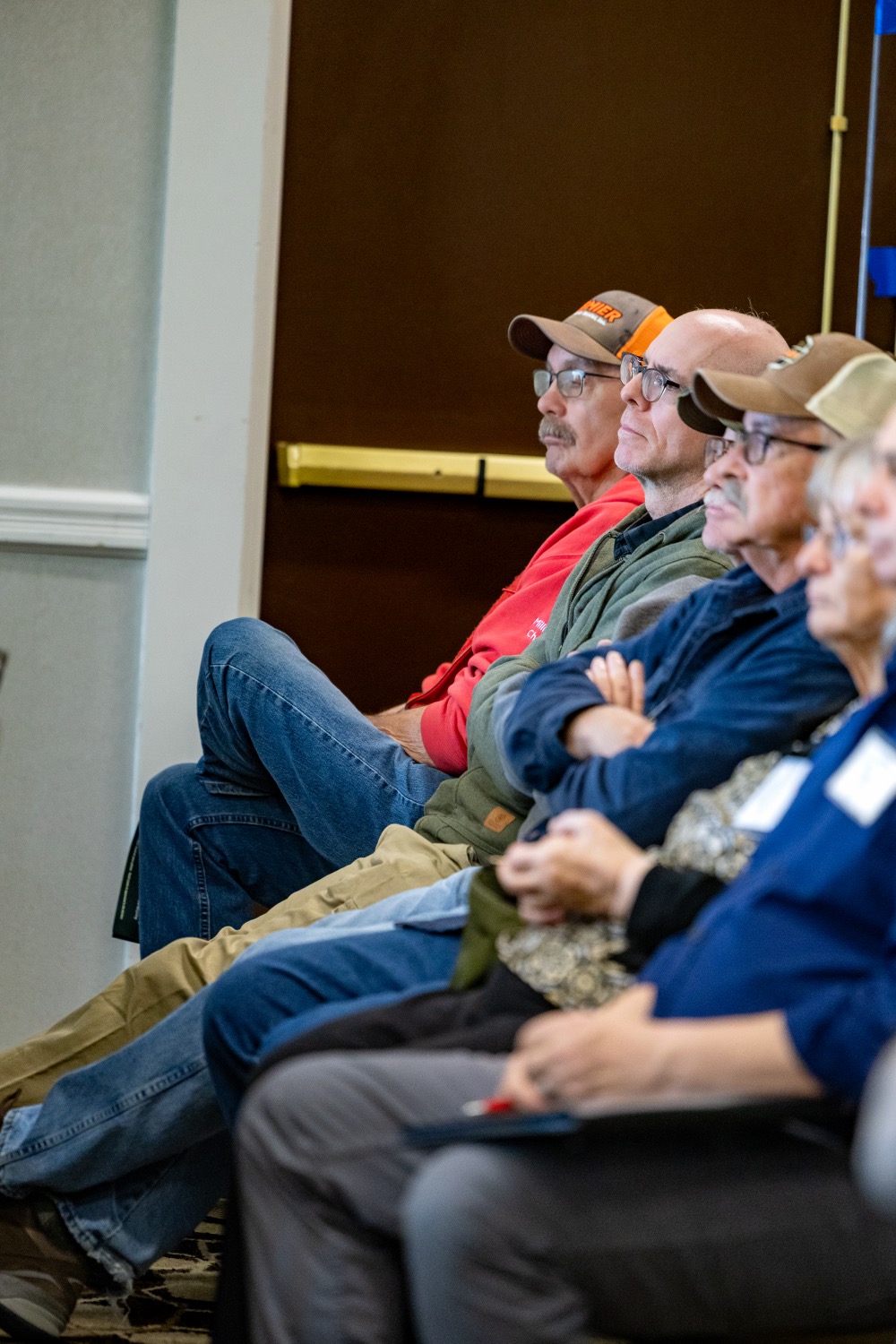 a line of people sitting and listening intently