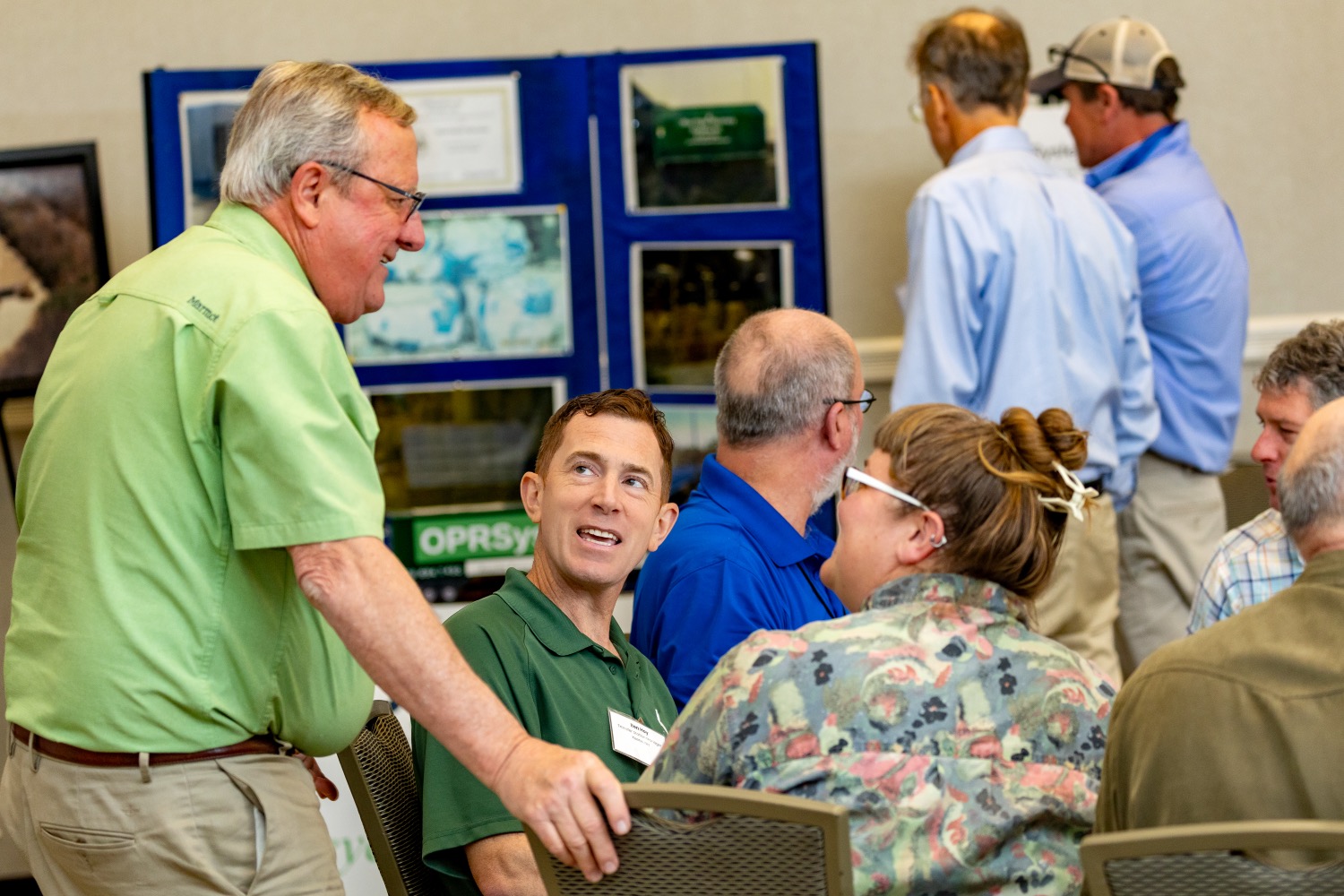 people visiting and laughing at a conference table