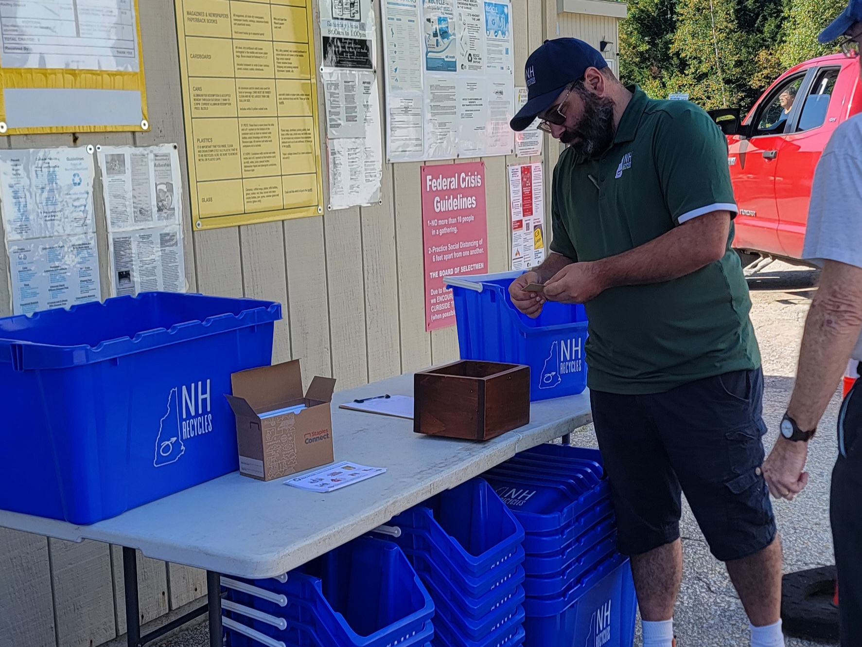 Brian handing out a gift card and recycling totes