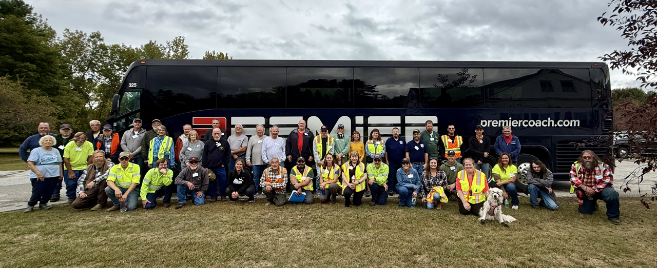 bus with group of people standing in front of it
