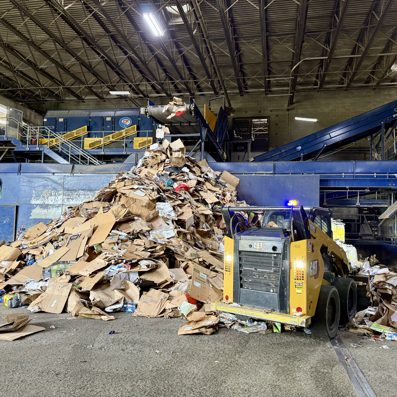 pile of cardboard and a loader