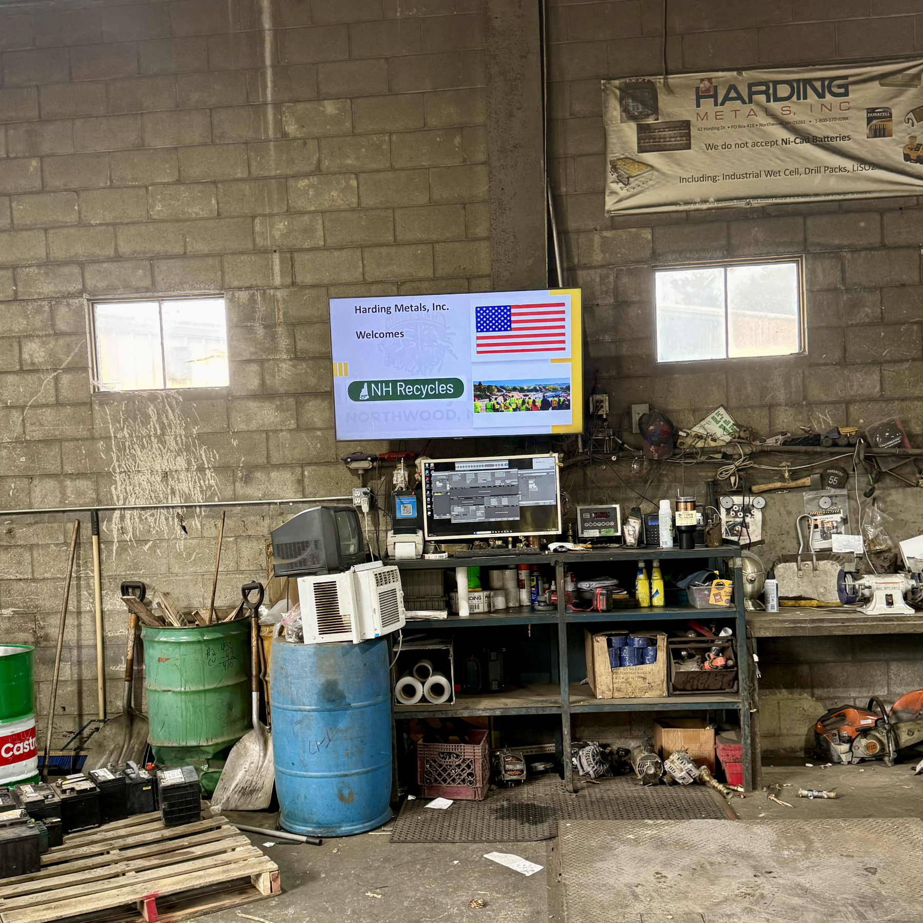 Sign in a workroom saying "Harding Metals Welcomes NH Recycles"