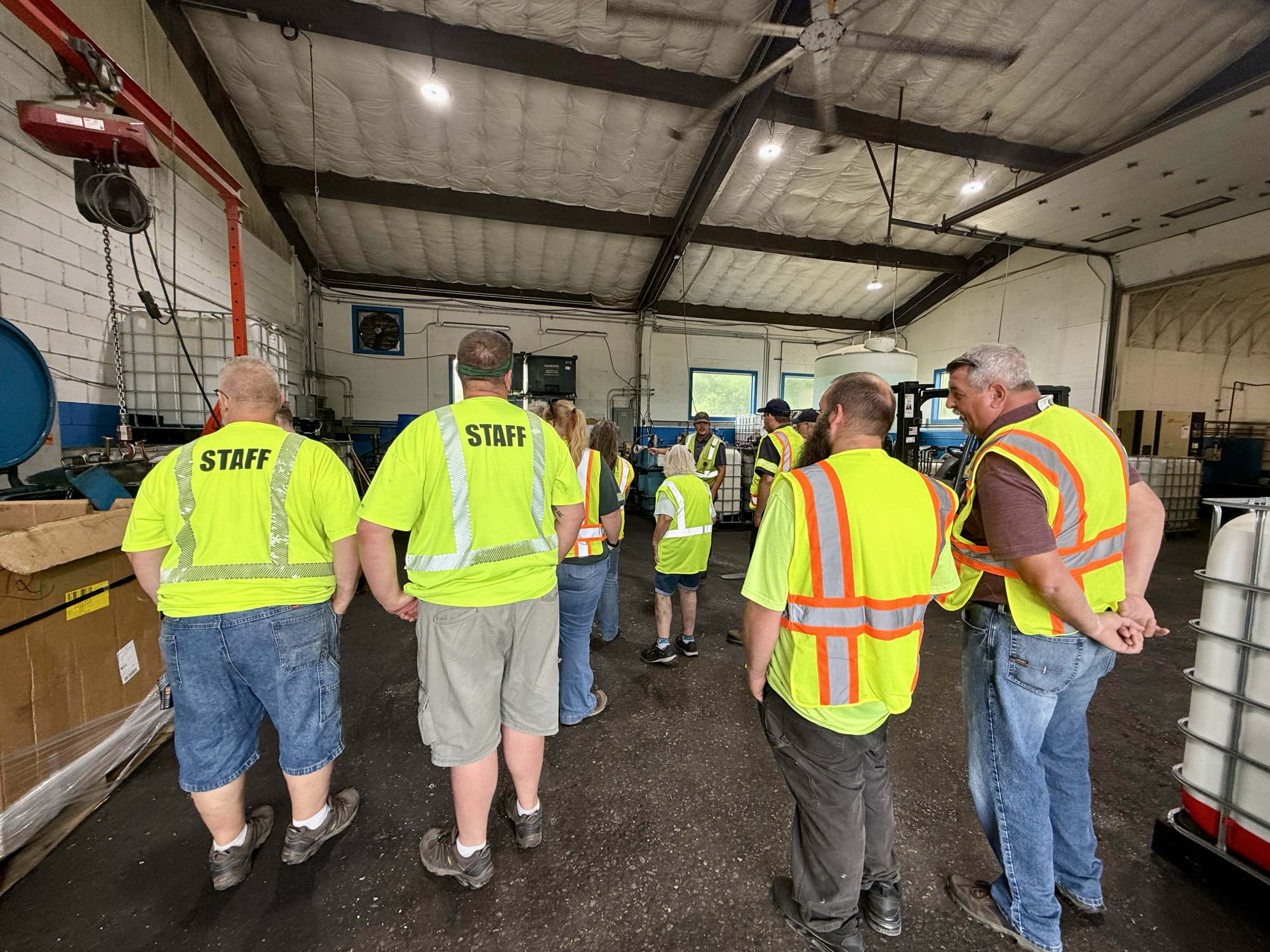 group of people looking at metal turnings and oil recycling