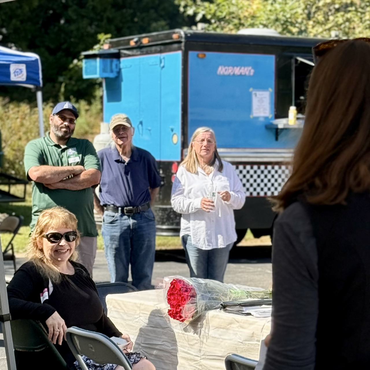 Close up of smiling Paula while Reagan shares remarks