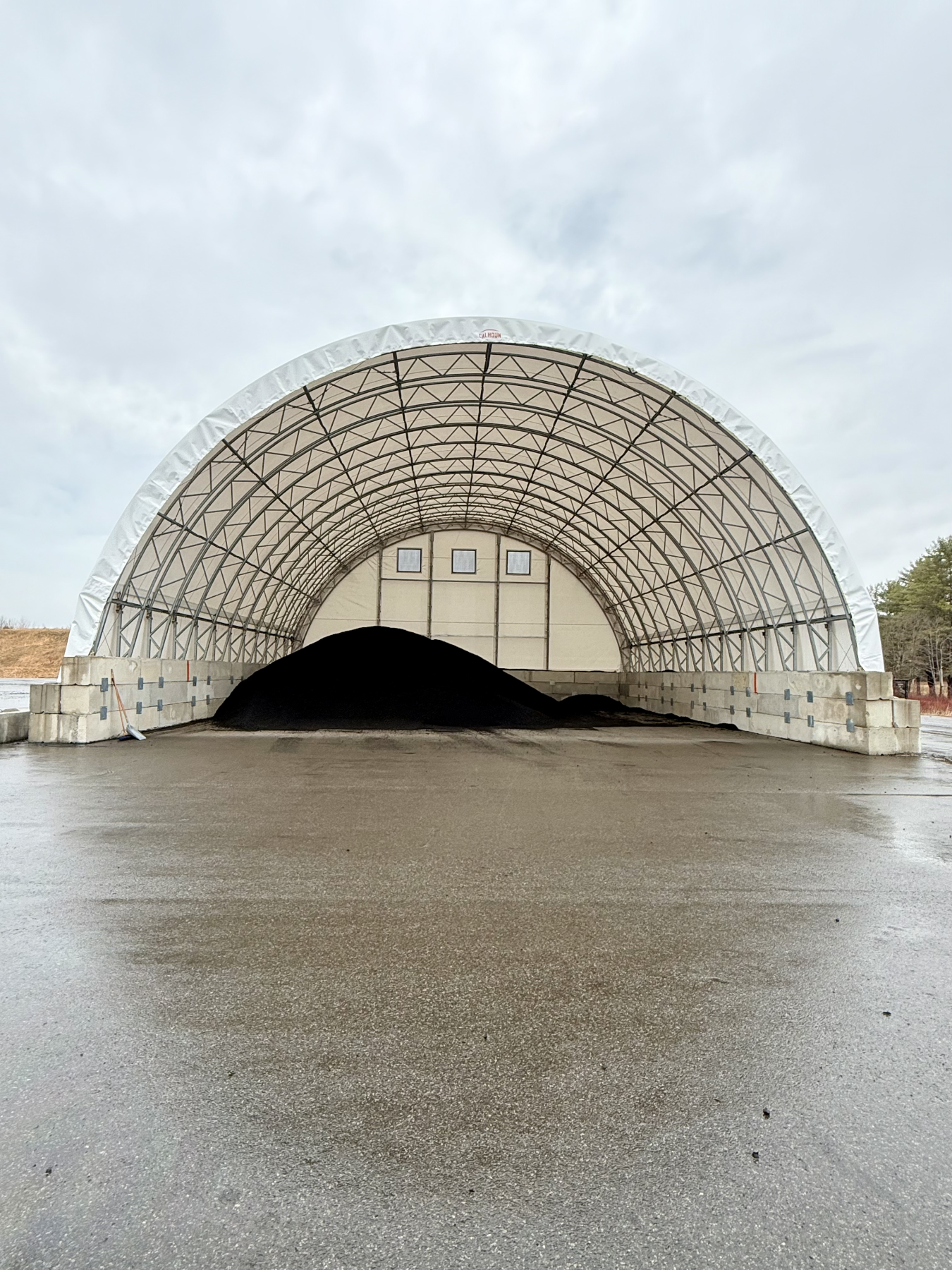 rubber chips being kept dry under a tent