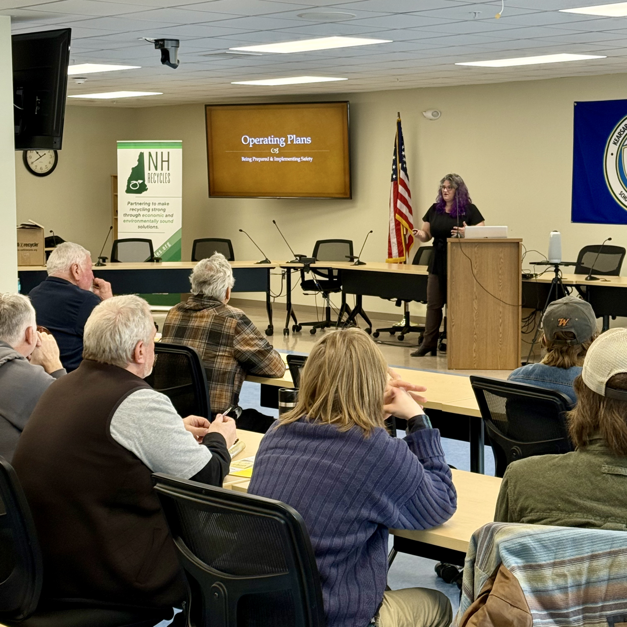 Tara Albert explaining Operating Plans to a group of adults in a classroom