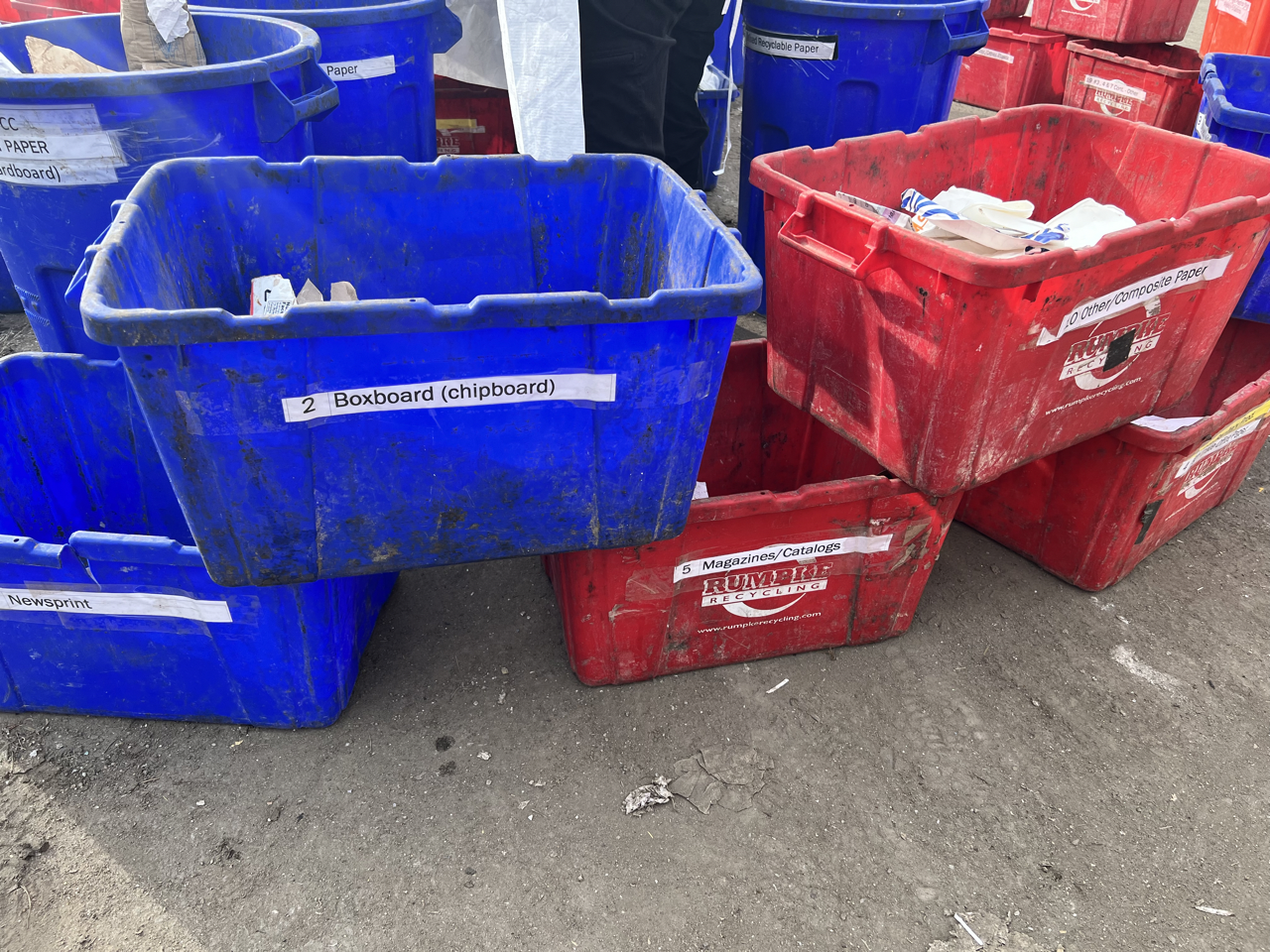 red and blue bins for different paper products like boxboard and magazines