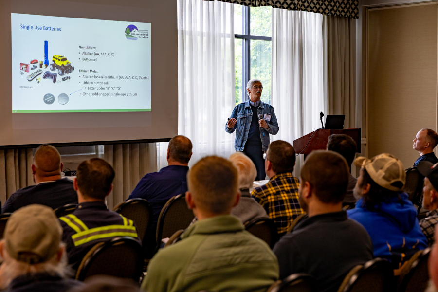 man in jean jacket giving talk on single use batteries