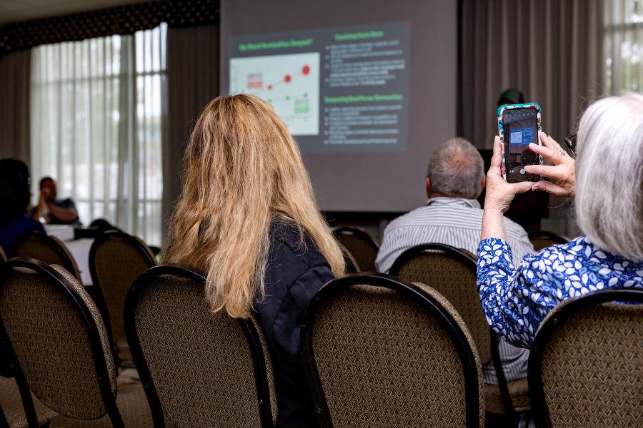 woman taking photo of workshop presentation screen