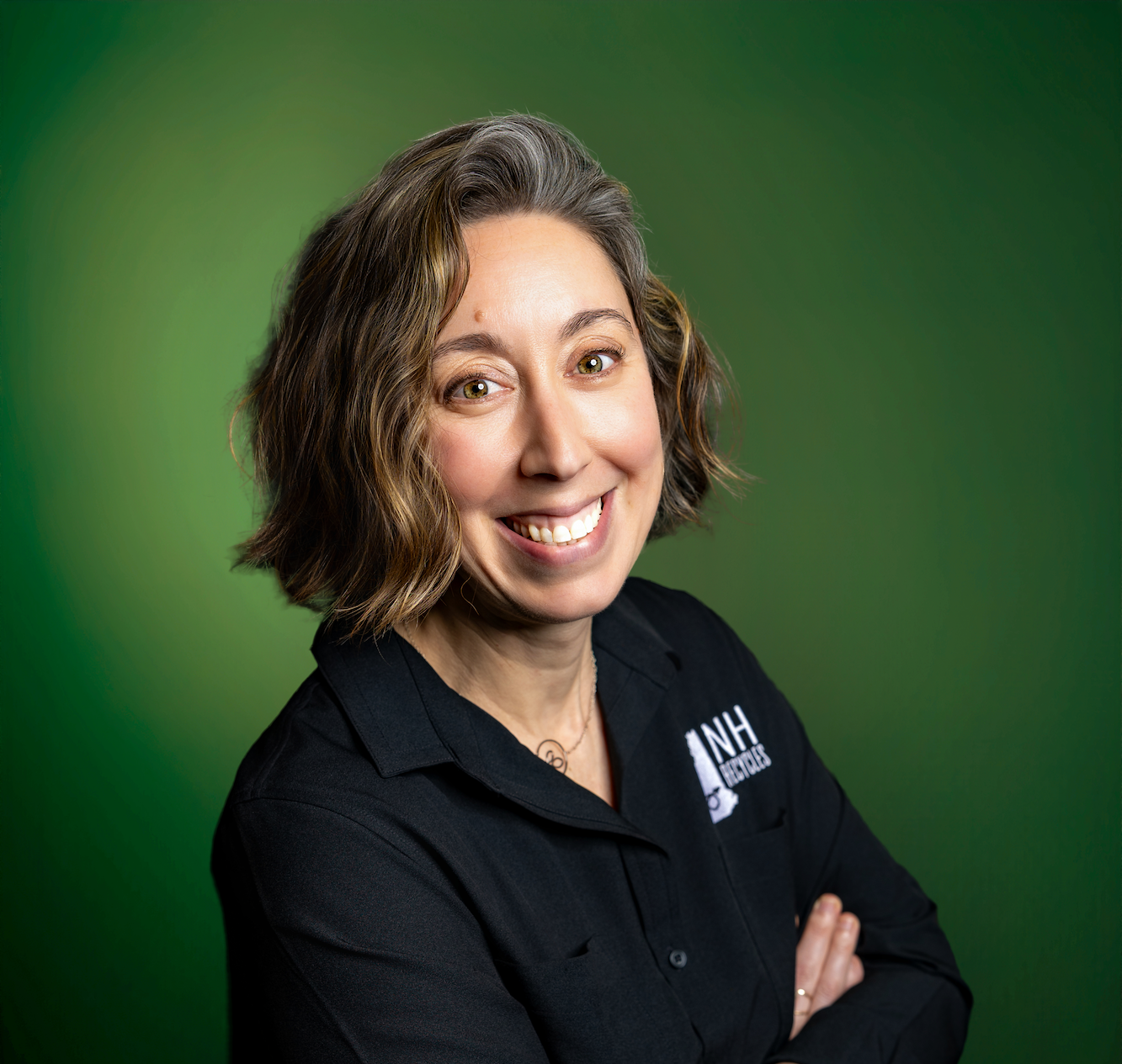 smiling woman in black shirt on green background